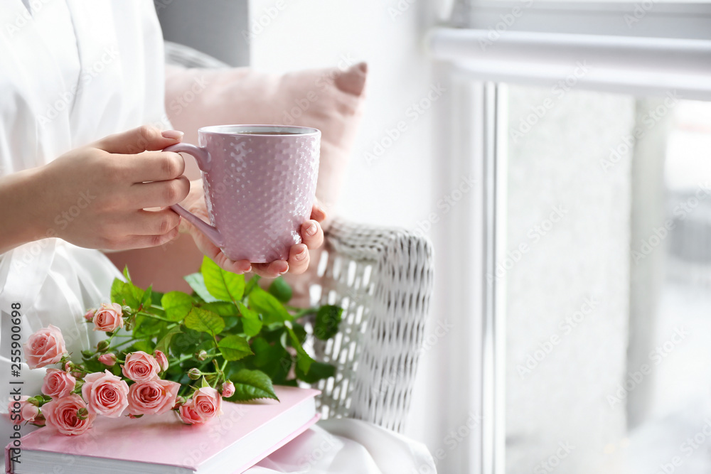 Woman drinking hot tea at home