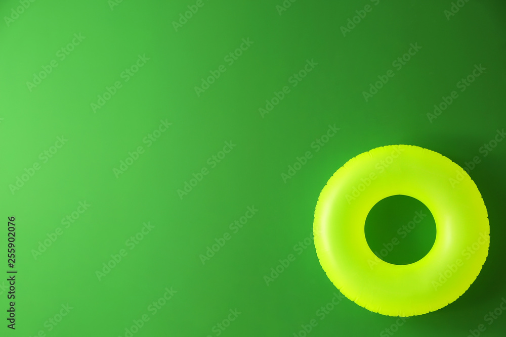 Bright inflatable ring on color background