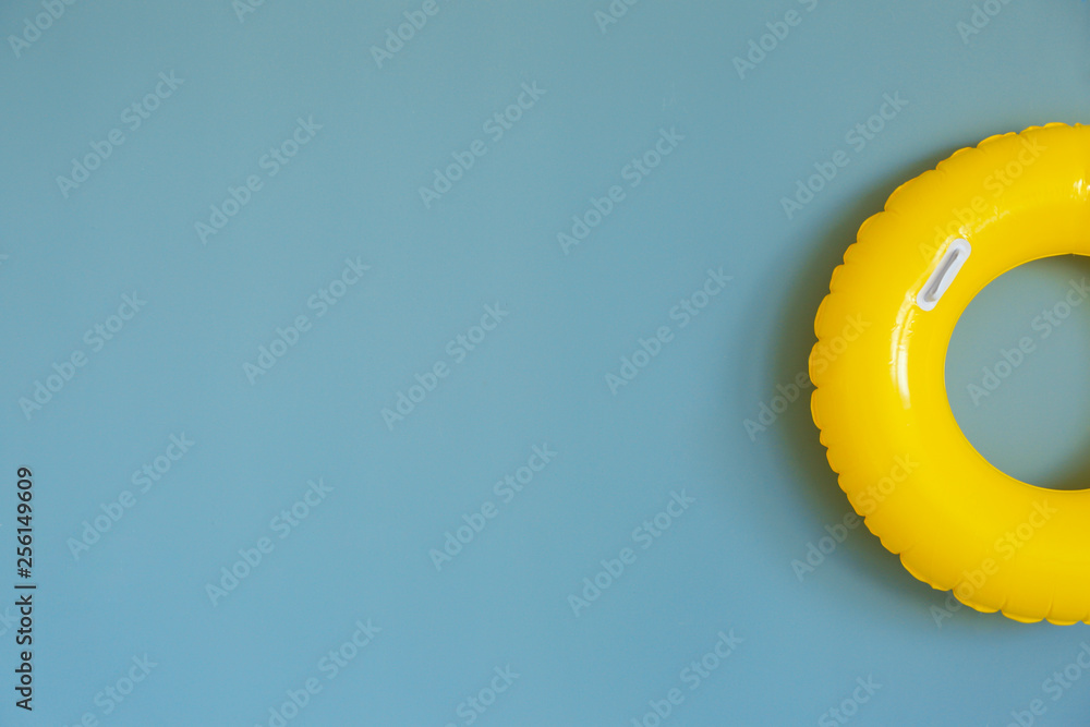 Bright inflatable ring on color background