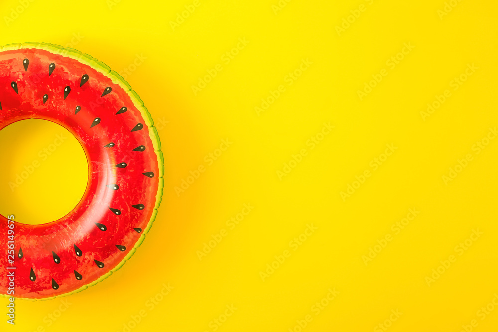 Bright inflatable ring on color background