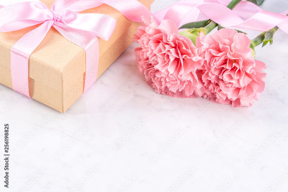 May mothers day handmade giftbox idea concept, beautiful blooming carnations with baby pink ribbon b