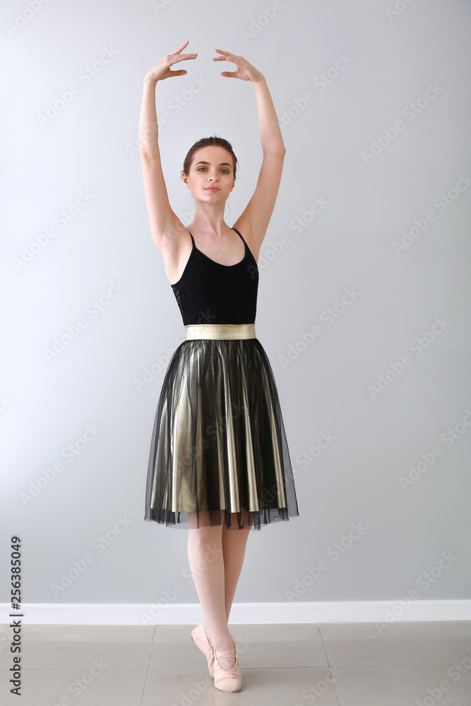 Beautiful young ballerina in dance studio