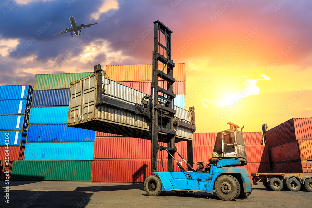 Forklift container loading and unloading cargo into the import-export zone