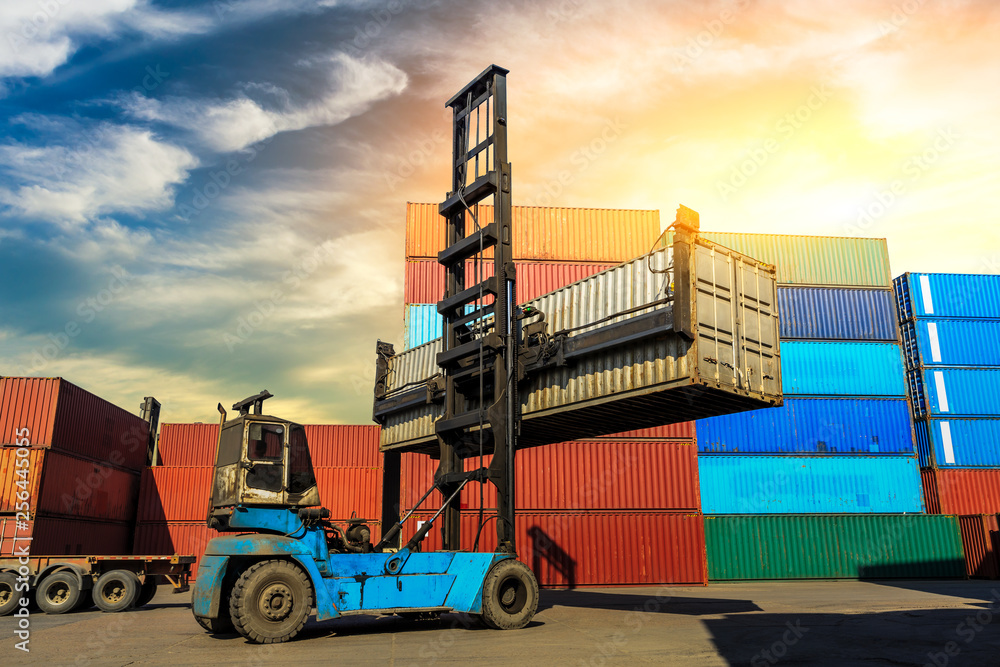 Forklift container loading and unloading cargo into the import-export zone