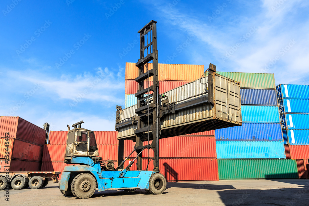 Forklift container loading and unloading cargo into the import-export zone