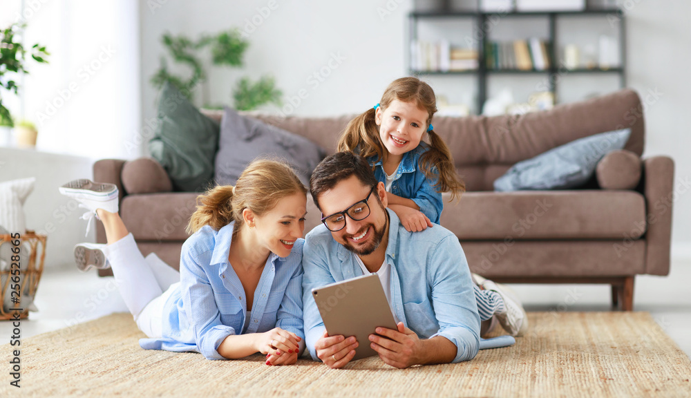 happy family. father, mother and child with tablet computer at home