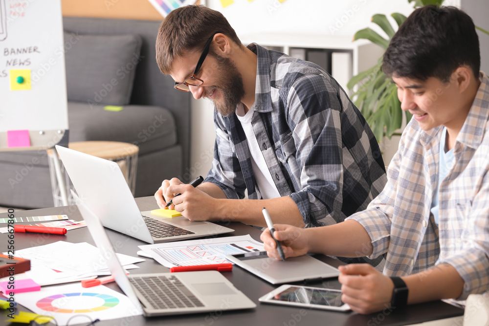 Young IT designers working in office