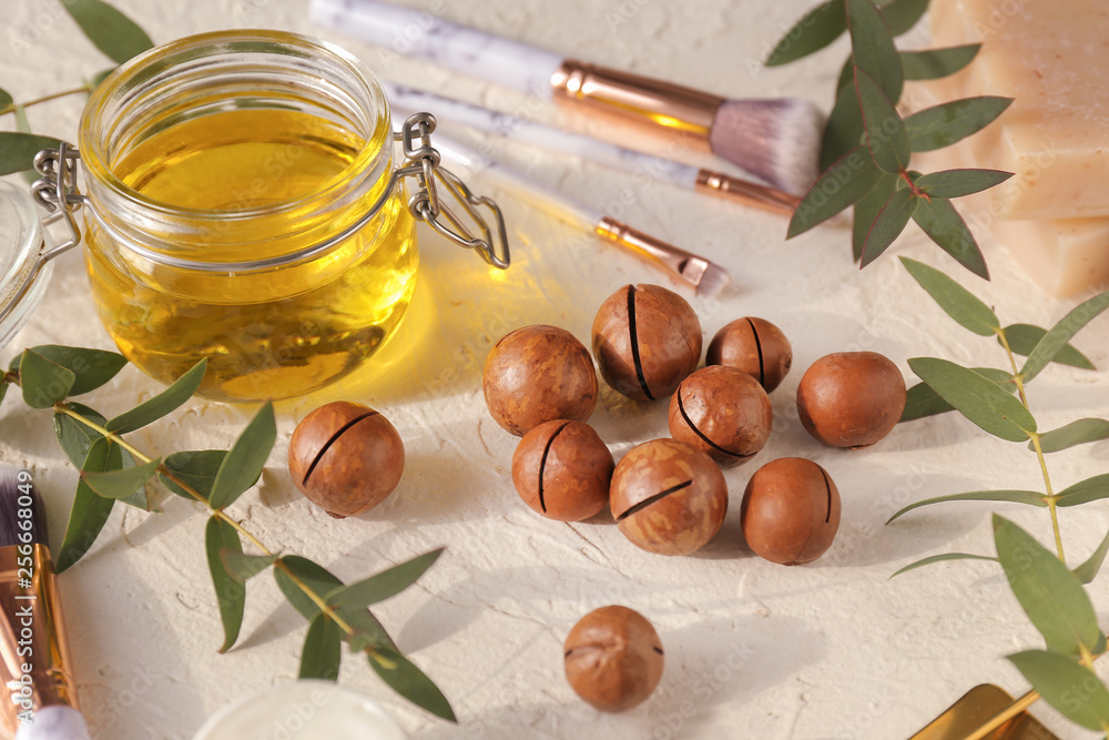 Macadamia nuts with oil on white table