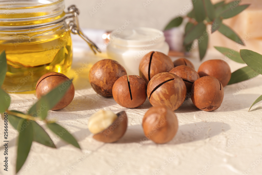 Macadamia nuts with oil on white table