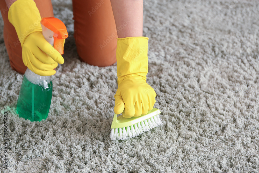 Woman cleaning carpet