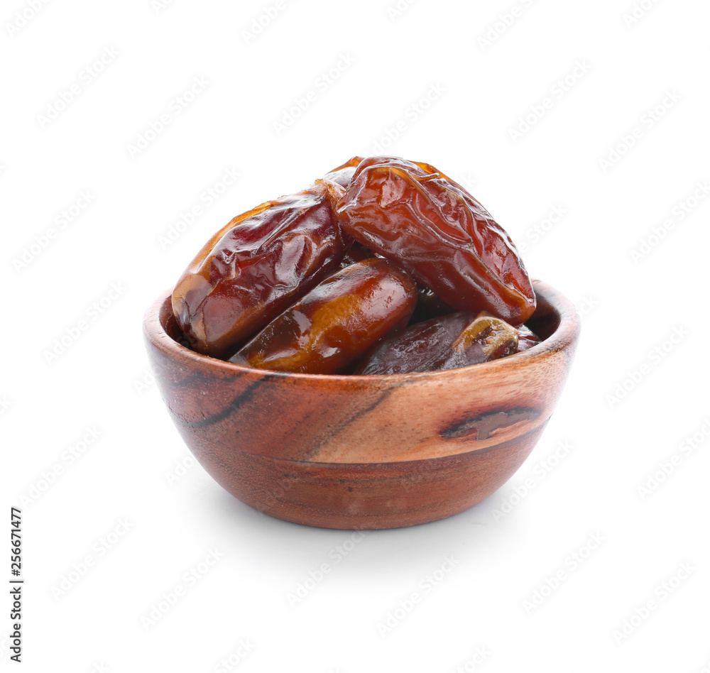 Bowl with tasty dried dates on white background