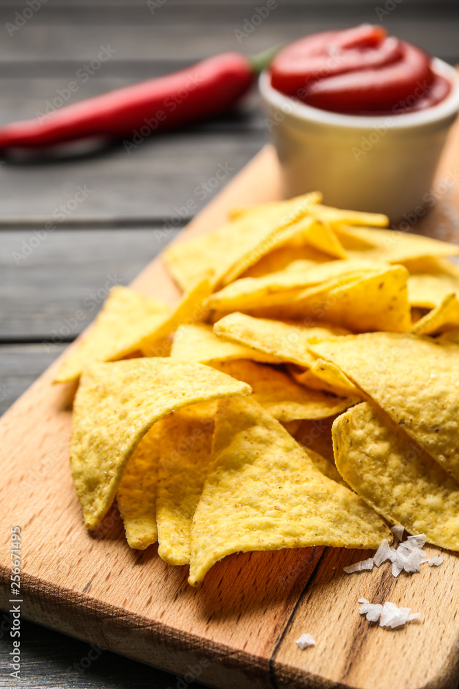 Board with tasty nachos on table