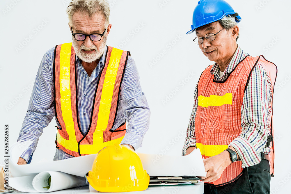 Senior engineers and architect working with construction plan. House building concept.