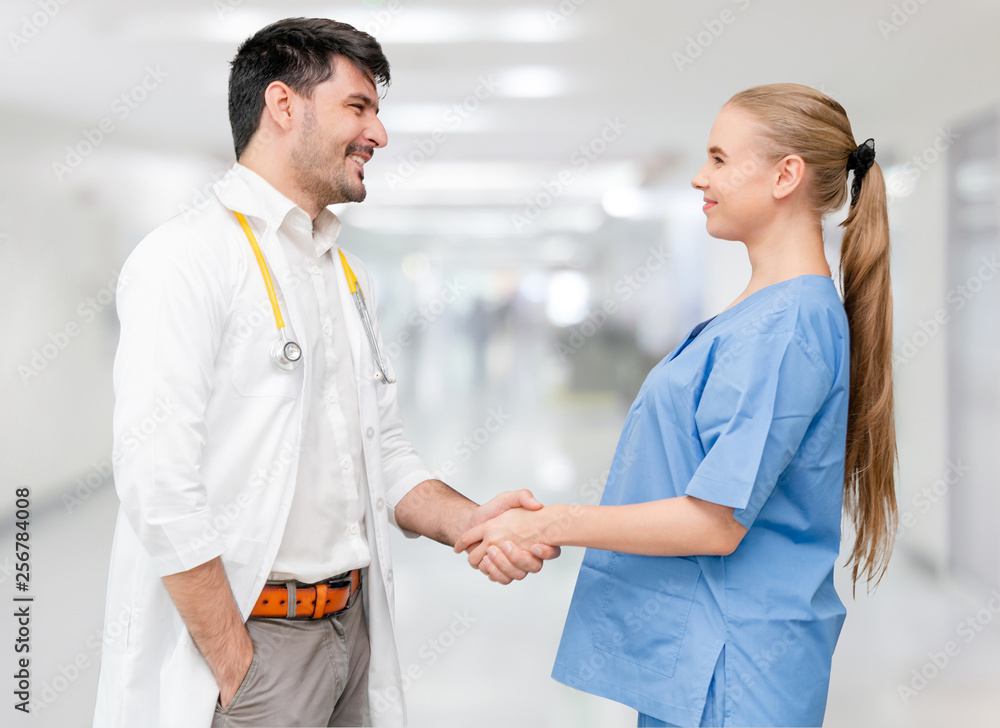 Doctor in hospital handshake with another doctor. Healthcare people teamwork and medical service con