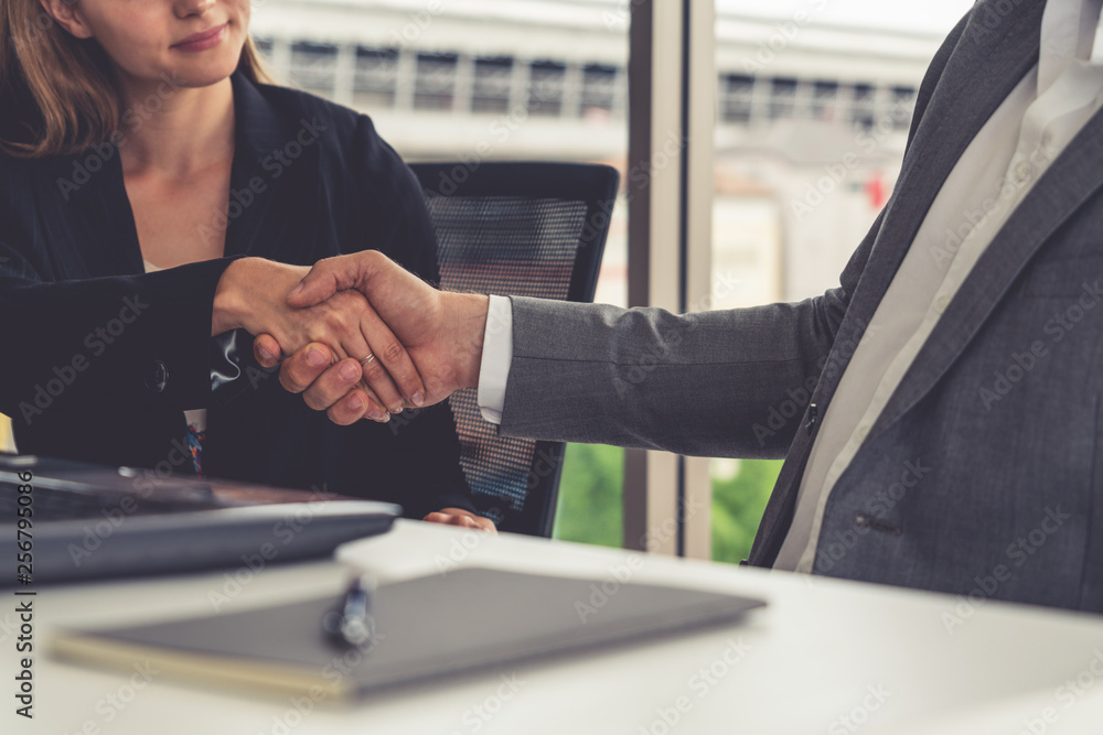 Businessman executive handshake with businesswoman worker in modern workplace office. People corpora