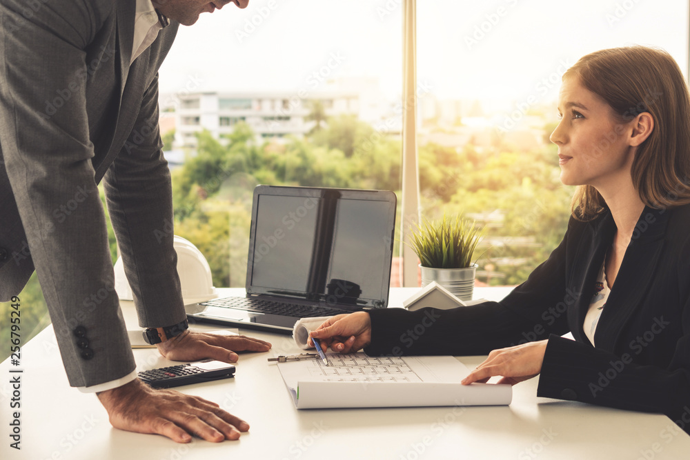 Architect and engineer working with construction drawing project on table in office. Architecture an