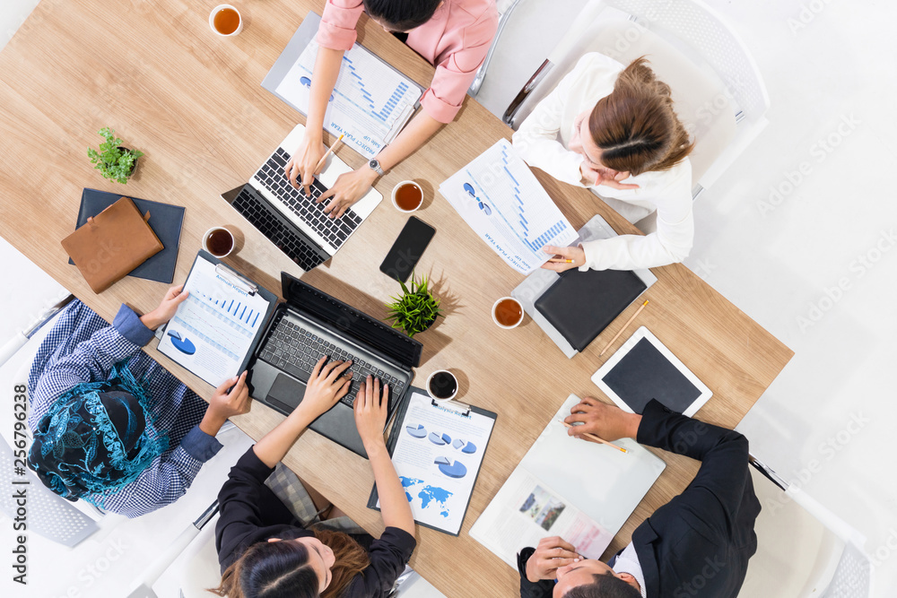 Top view of businessman executive in group meeting with other businessmen and businesswomen in moder