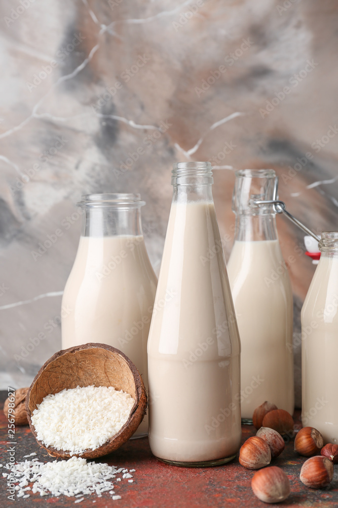 Assortment of tasty vegan milk on table