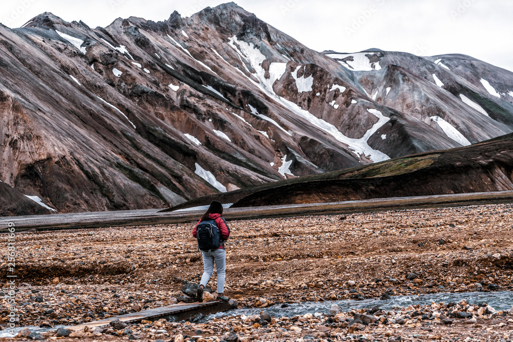 Traveler hiking at Landmannalaugar surreal nature landscape in highland of Iceland, Nordic, Europe. 