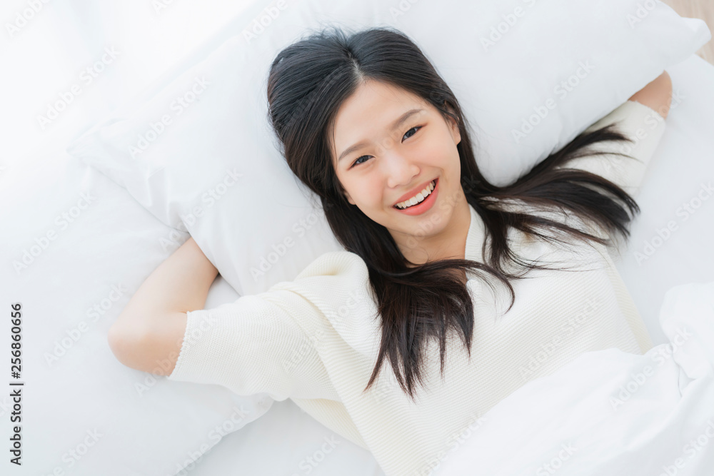 pretty beautiful asian woman peaceful sleep in white bedroom with nature sun light from window