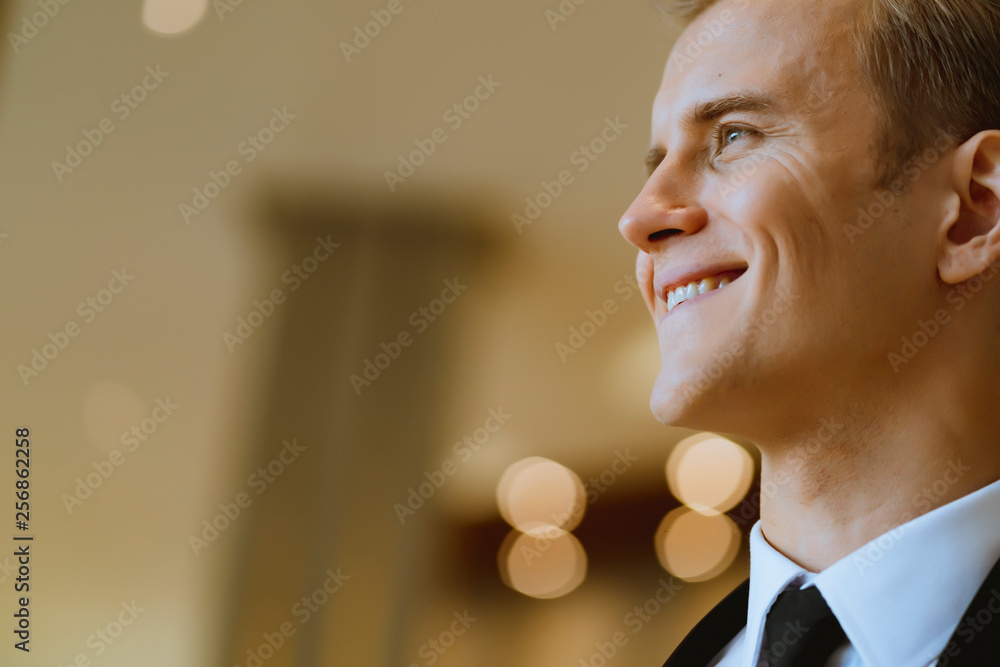 close up business caucasian man in black suit office background