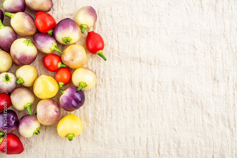 Fresh colorful peppers on burlap