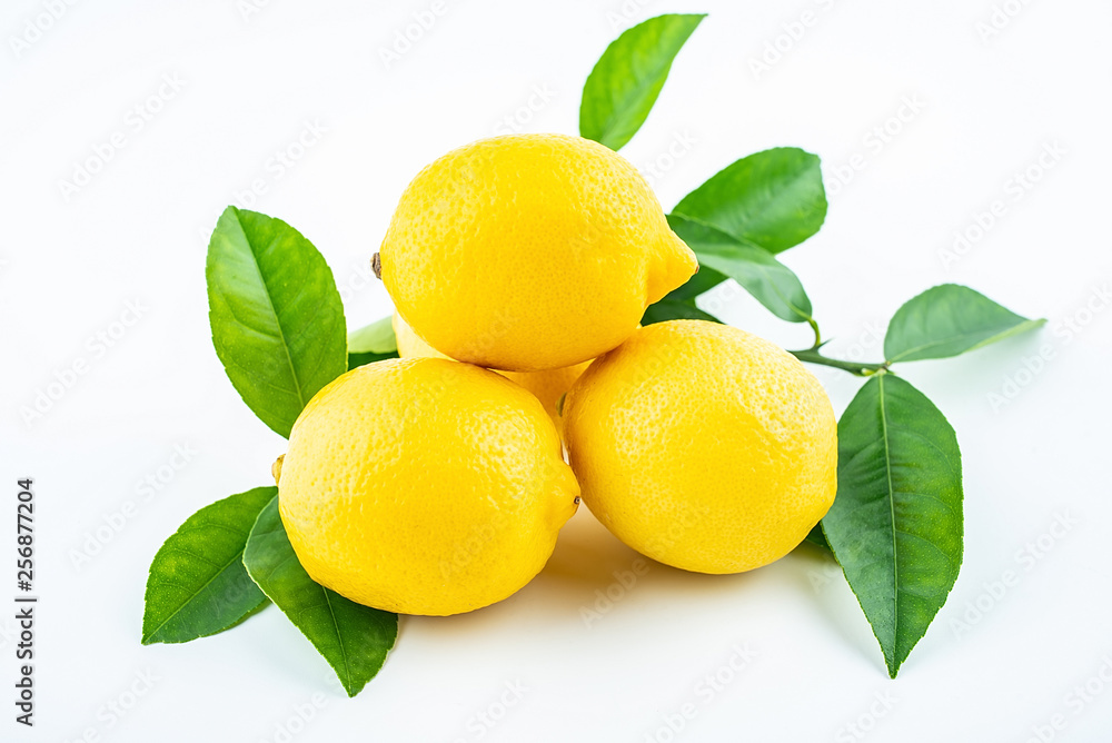 Fresh yellow lemon with leaves on white background