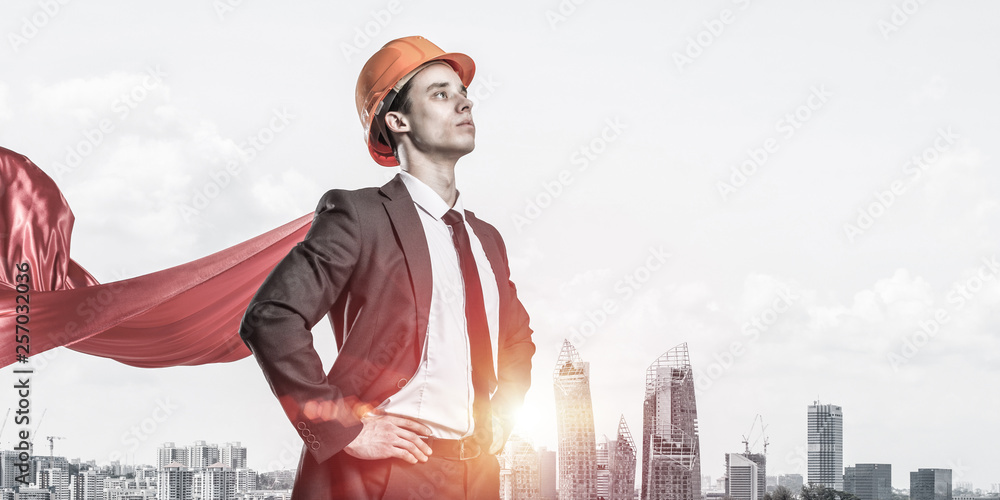 Concept of power and sucess with architect superhero in big city