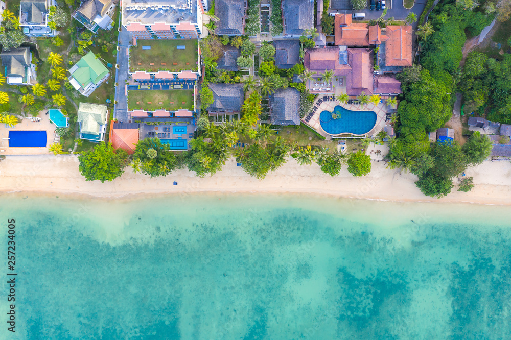 Aerial view of swimming pool with sea and beach in luxury hotel and resort for travel and vacation