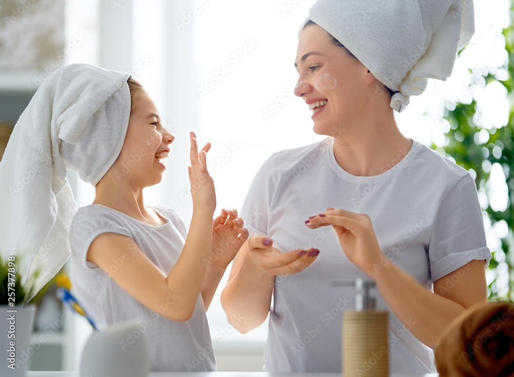 Mother and daughter caring for skin