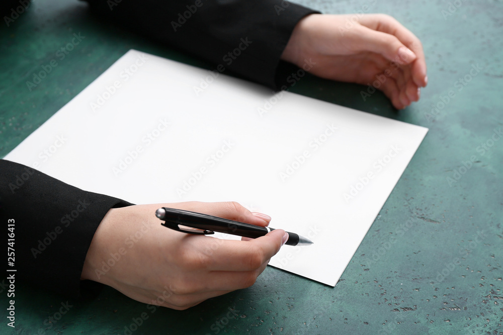 Businesswoman with sheet of paper at table. Concept of starting career from a blank slate