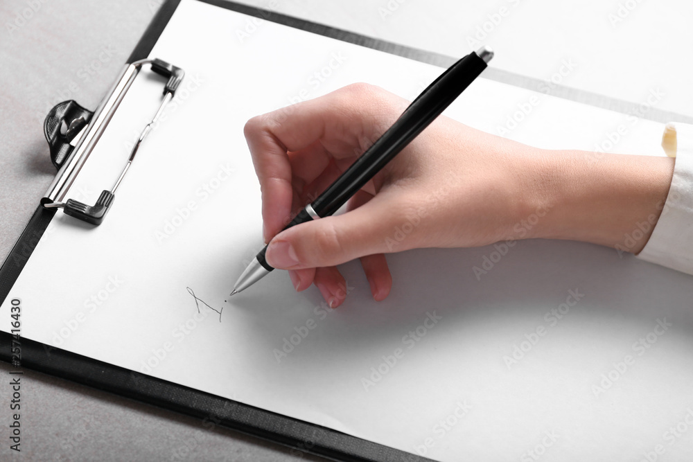 Woman writing figure 1 on sheet of paper at table. Concept of starting career from a blank slate