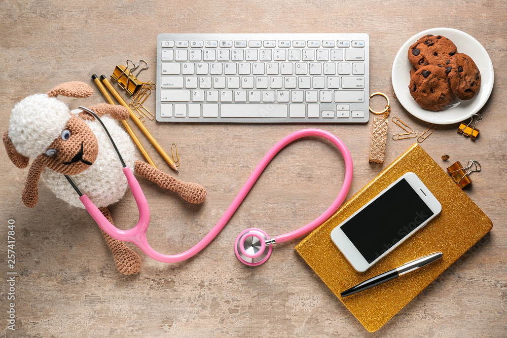 Workplace of pediatrician on grey background