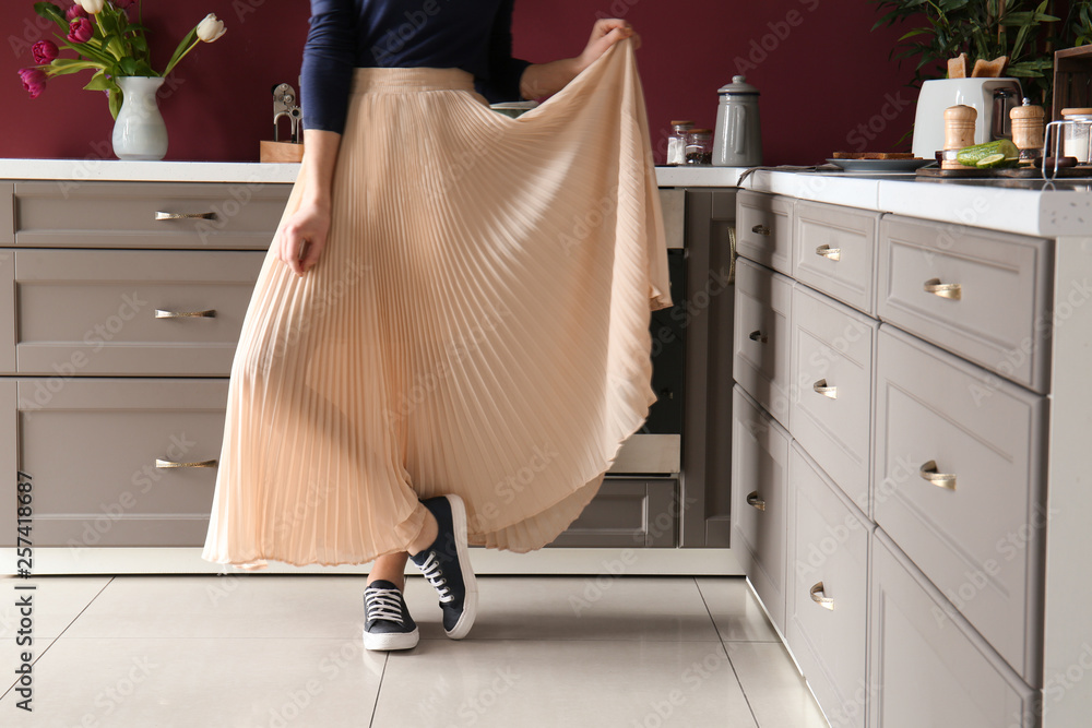 Young stylish woman in modern interior of kitchen