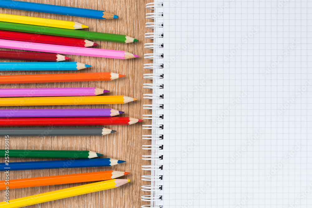 Idea of school still life with pencils and notebook on desk