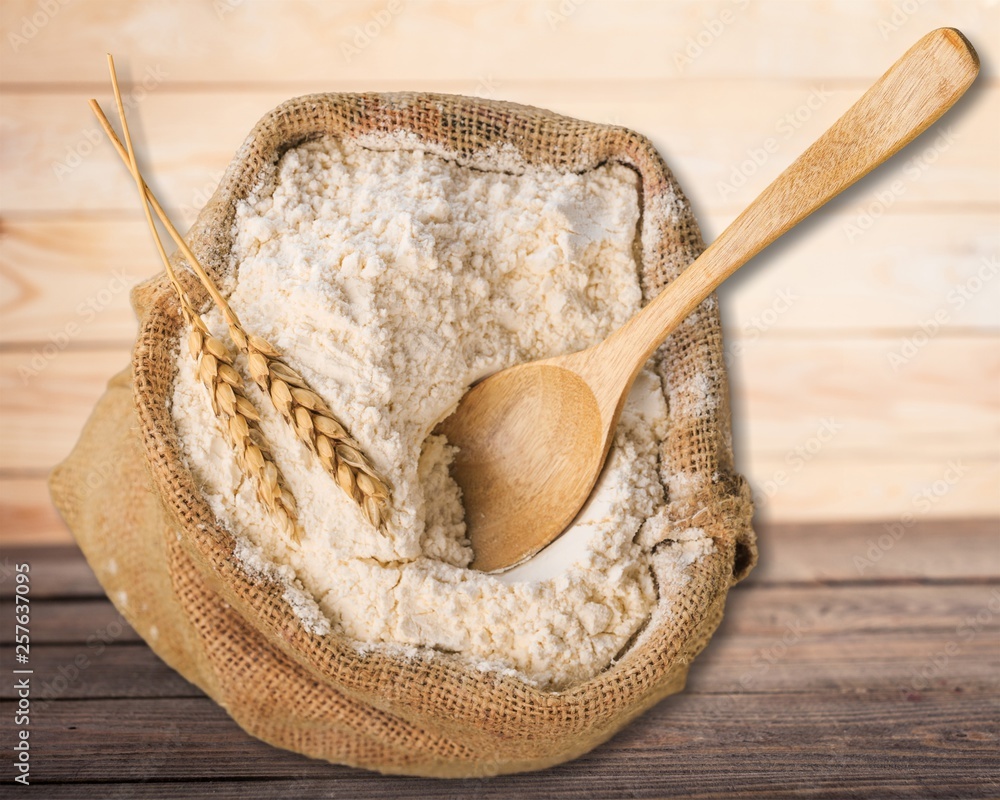 Wheat ears and flour on  background