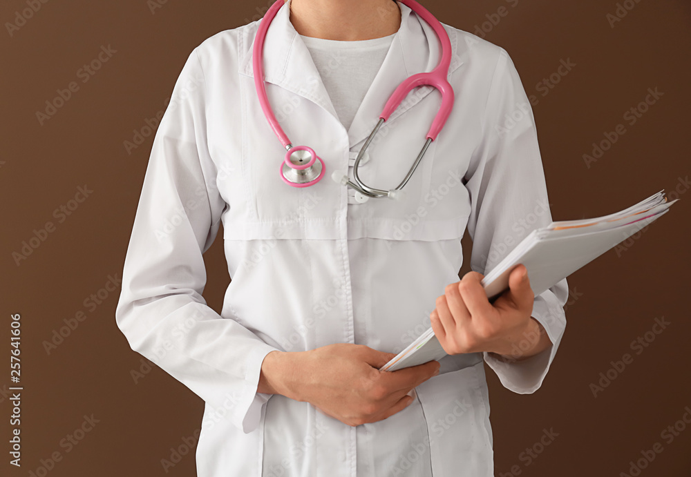 Female doctor on color background