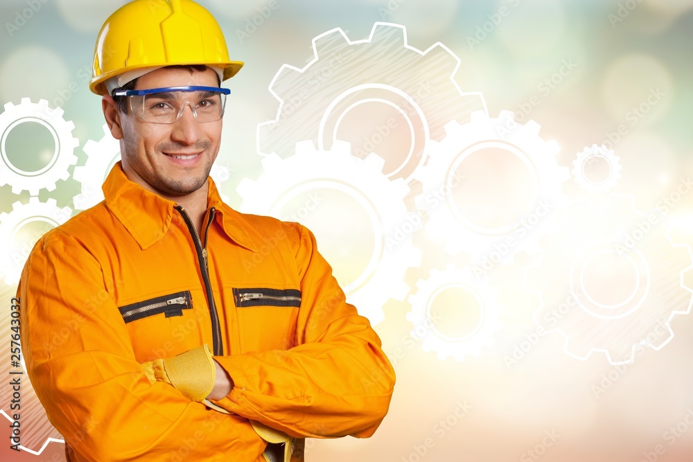 Young man in work uniform and yellow helmet