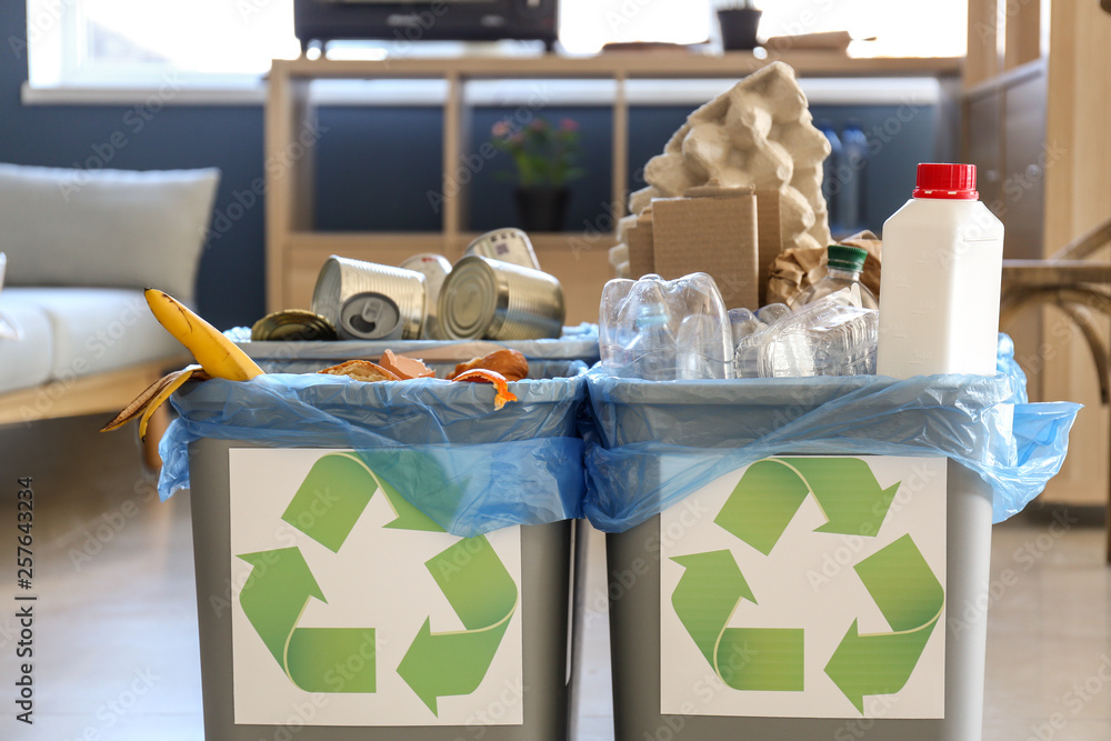 Containers with different types of garbage indoors