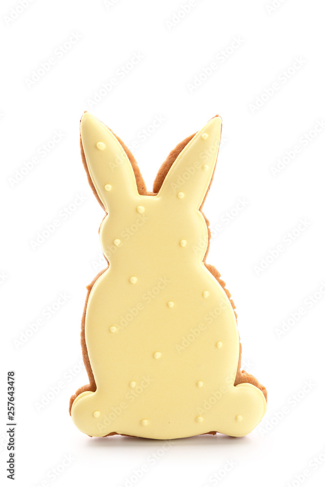 Tasty Easter cookie in shape of bunny on white background