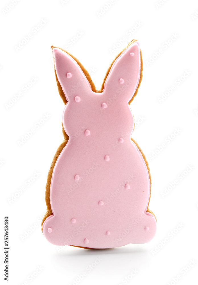 Tasty Easter cookie in shape of bunny on white background