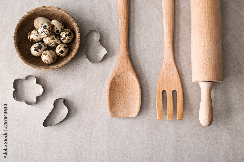 Kitchen utensils, eggs and cookie cutters on table