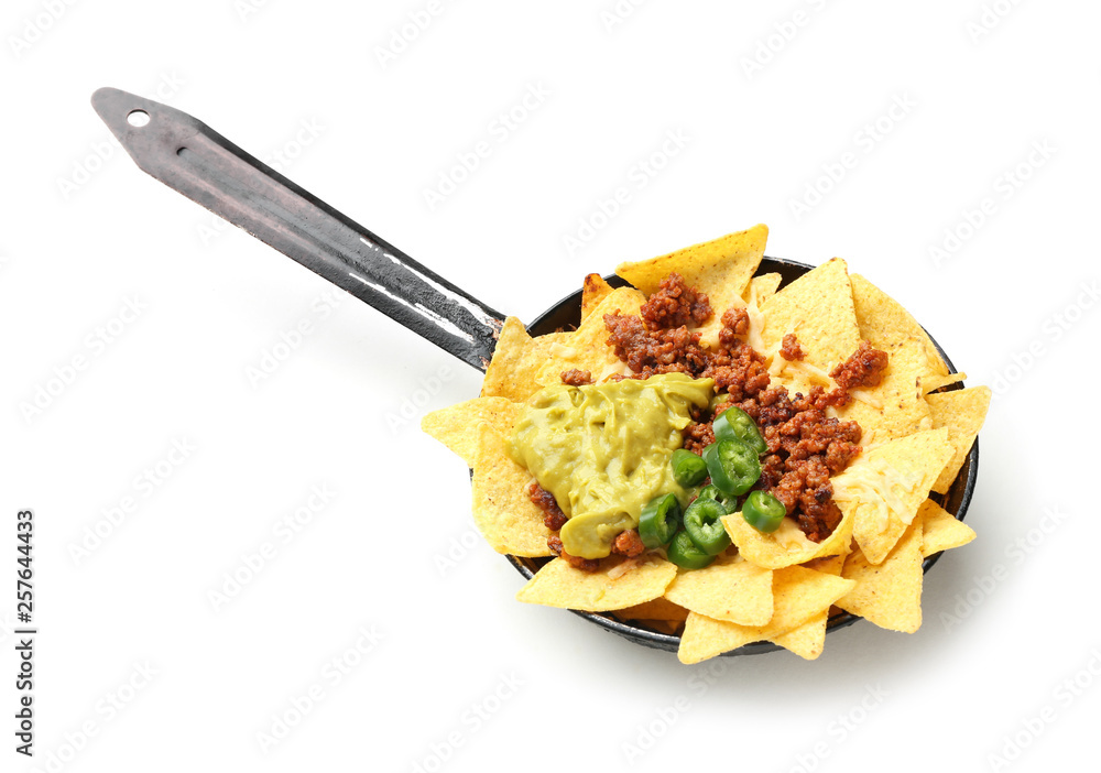 Frying pan with tasty nachos, minced meat, chili and guacamole on white background