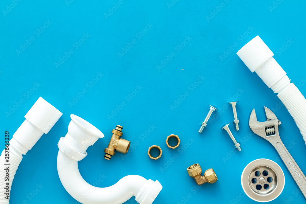 Plumber work with instruments, tools and gear on blue background top view mockup