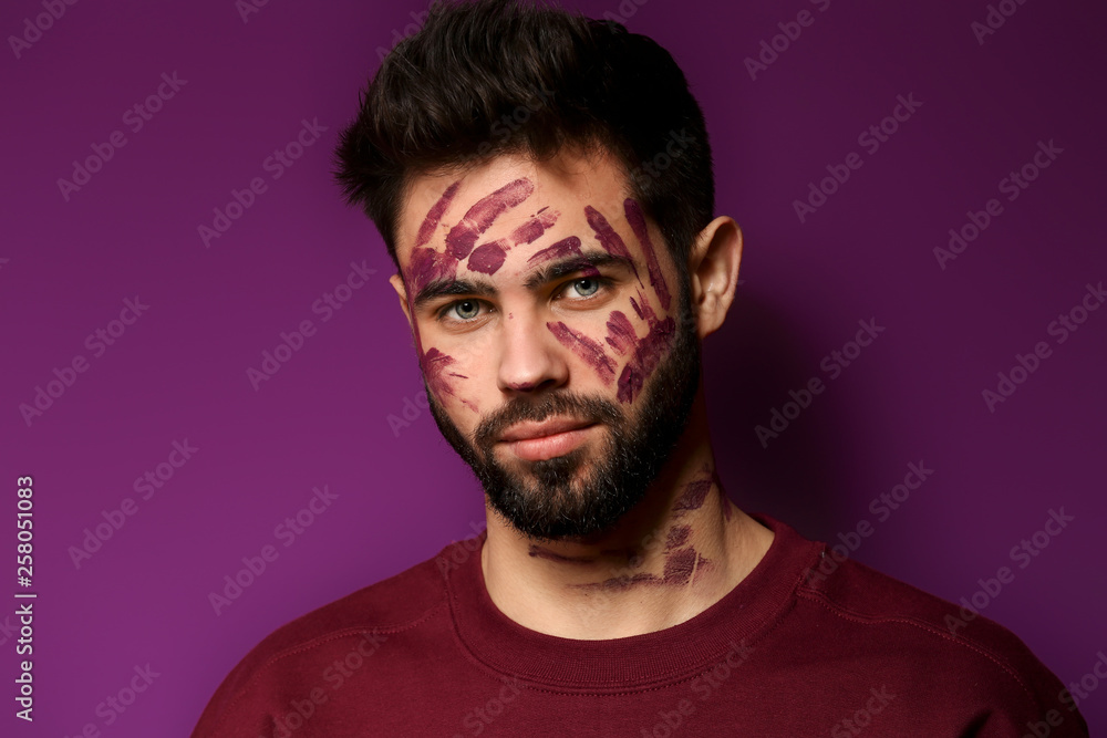 Portrait of handsome man with paint on his face against color background