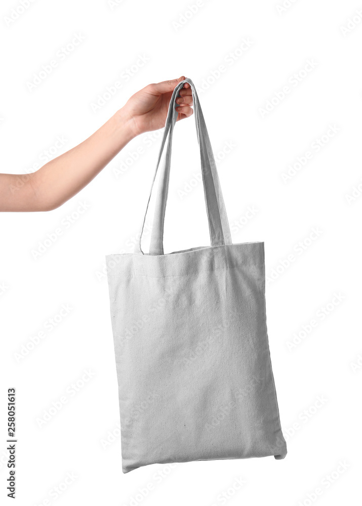 Female hand holding eco bag on white background