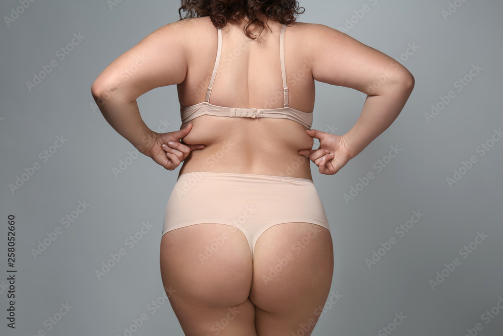 Overweight woman on grey background