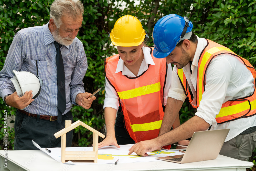 Engineer, architect and business man working on the engineering project at construction site. House 