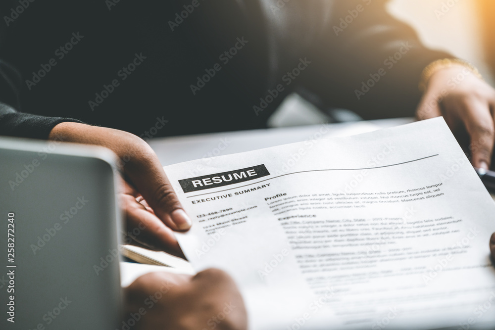 Close up view of employee candidate hands CV resume document to the interviewer HR human resources d