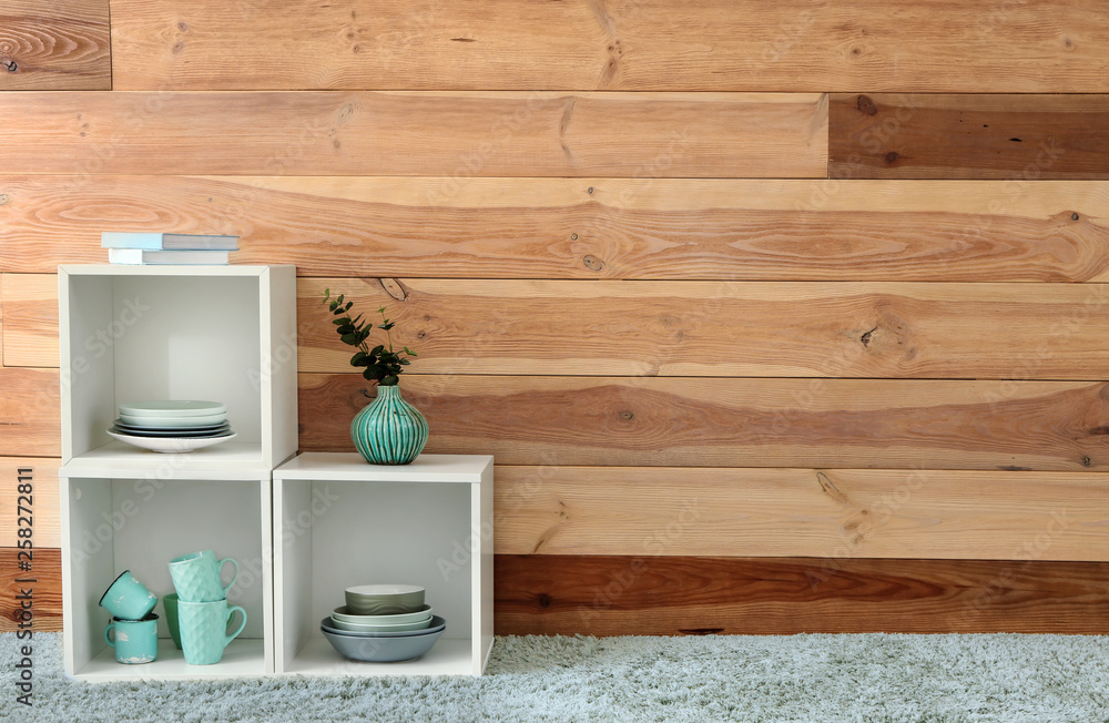 Shelf unit near wooden wall